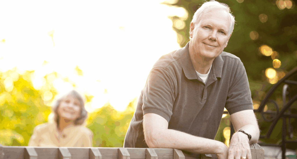 Man leaning on fence