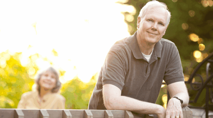 Man leaning on fence