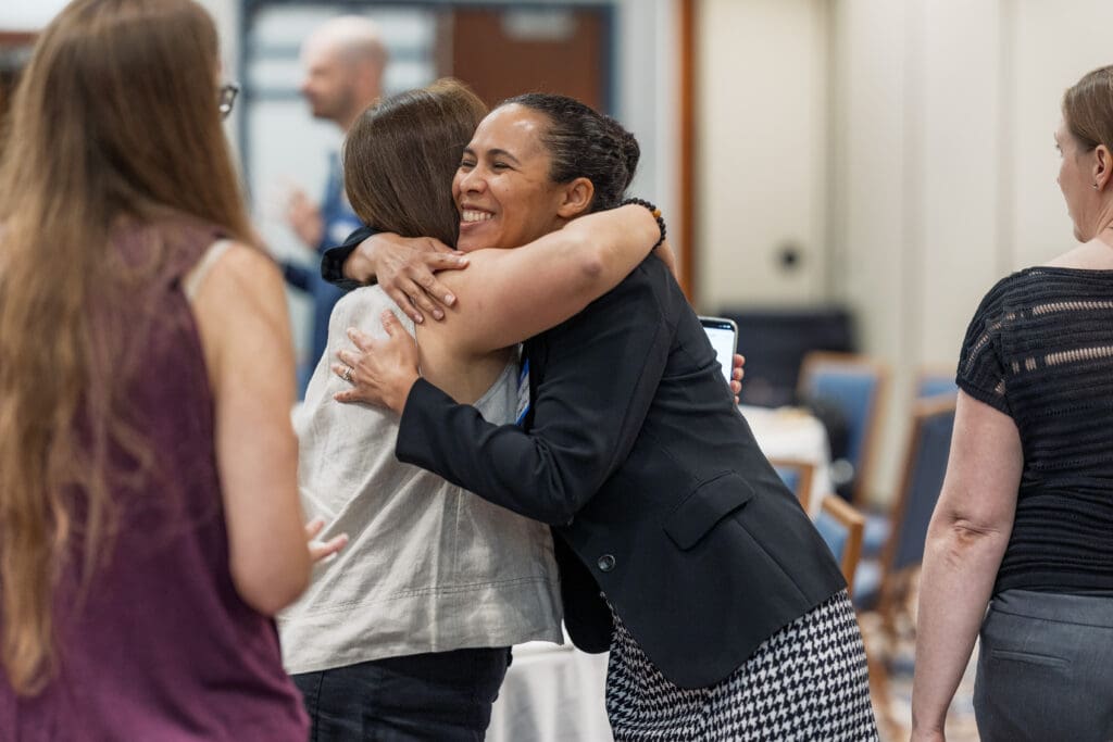 People hugging at MoCo EO Roundtable